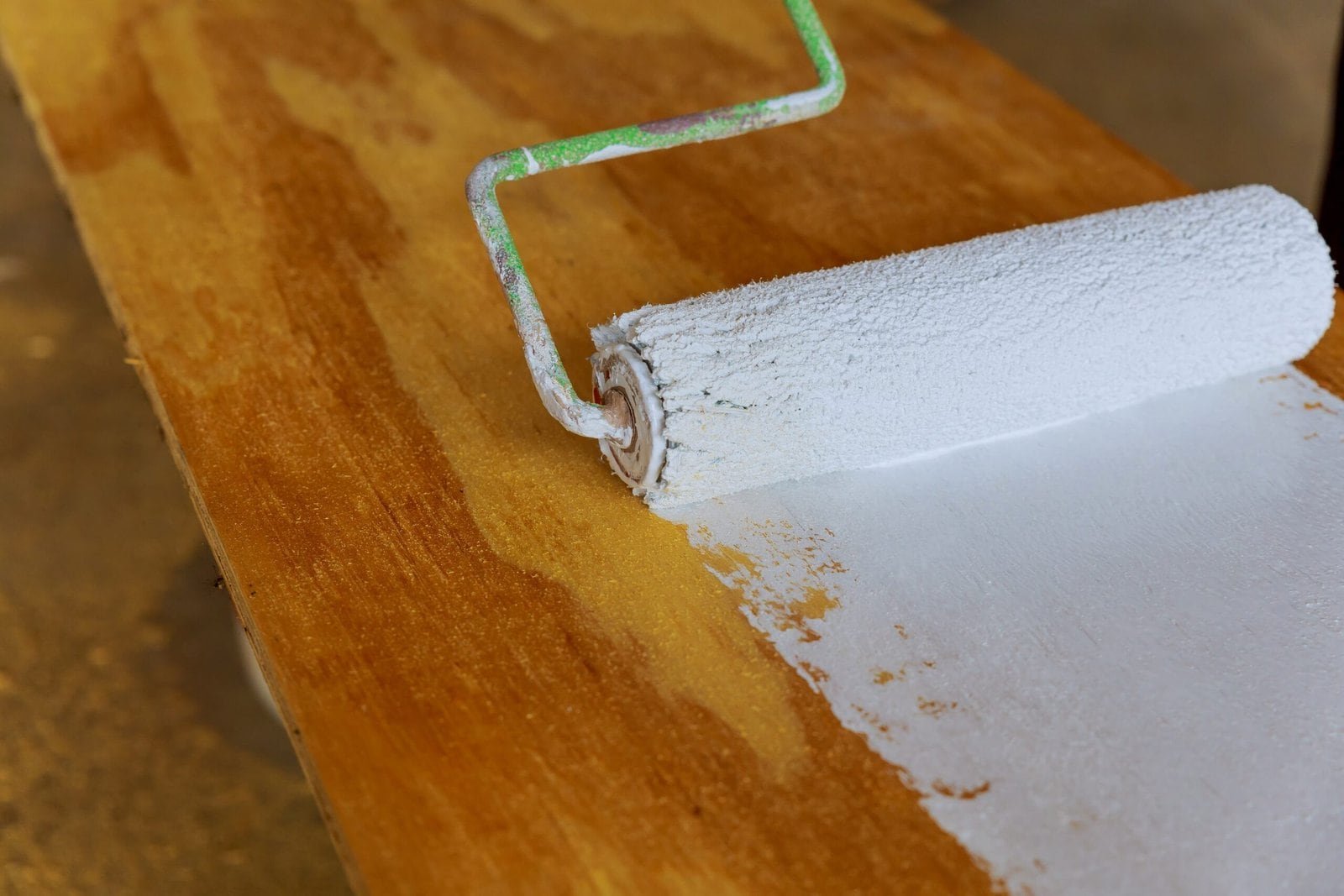 painting the wood with white paint roller painting the wood with white paint roller House painting,paint roller